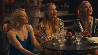 Kate, Jaclyn, and Laurie sit at a table in The White Lotus season 3