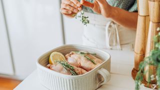 Head chef has revealed the top needed kitchen item - woman preparing chicken in kitchen
