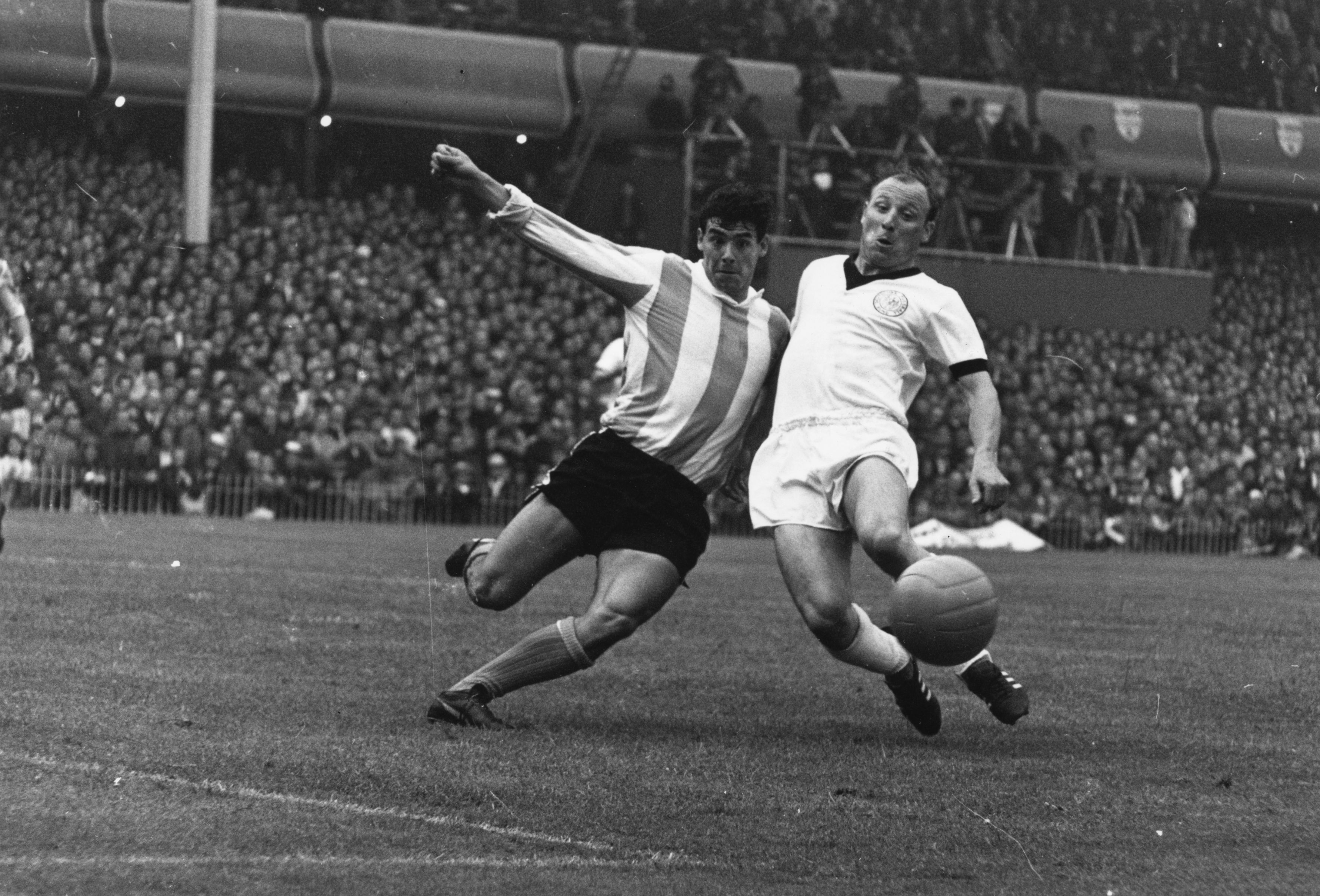 Argentina's Rafael Albecht competes for the ball with West Germany's Uwe Seeler at the 1966 World Cup.