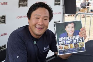 ming hao tsai hosts up a copy of his cook book