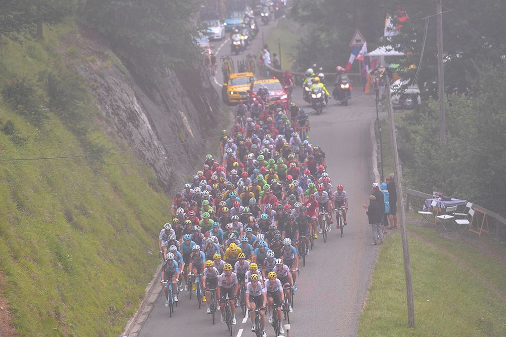 The peloton climbs into the fog during stage 12 at the Tour de France