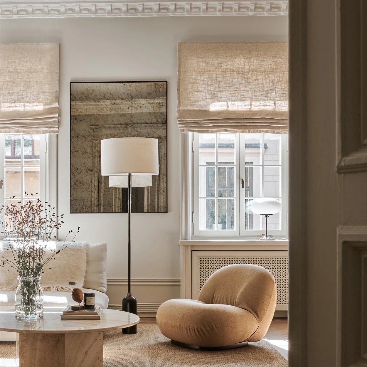 A contemporary living room with linen roman blinds