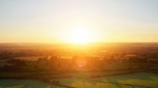 A sunrise over some fields