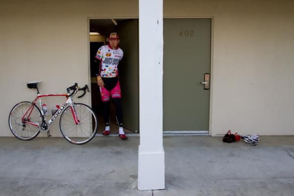 Sean Mazich heads out of his hotel room shortly before a daily training ride. Training camp marks the beginning of a long season of hotel stays for the eleven-member team, ranging from luxury to much less so.