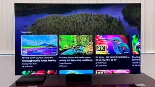 Samsung-QN900C TV on table with smart hub interface on screen