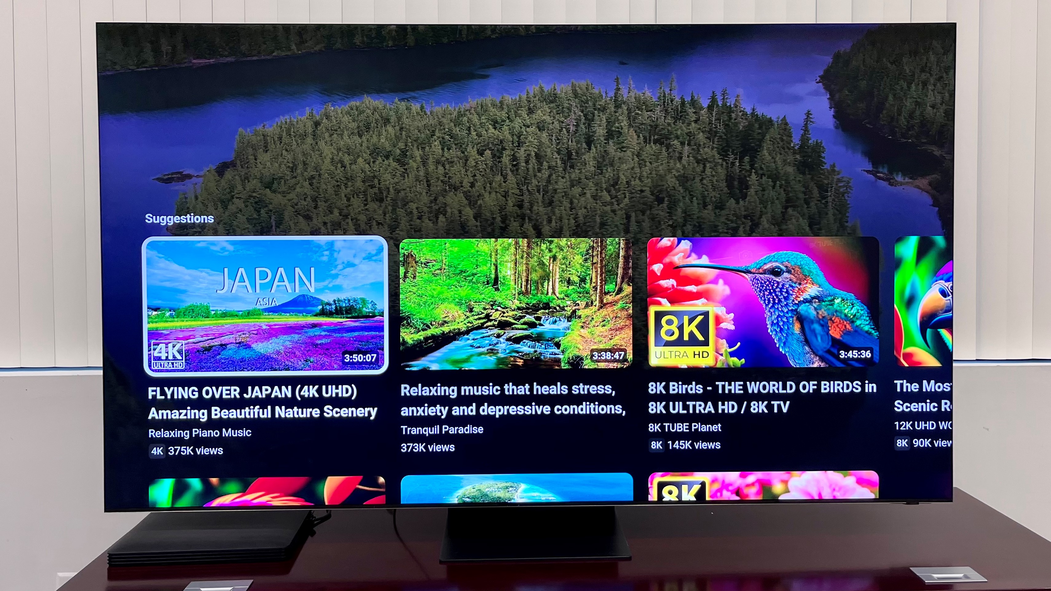 Samsung-QN900C TV on table with smart hub interface on screen