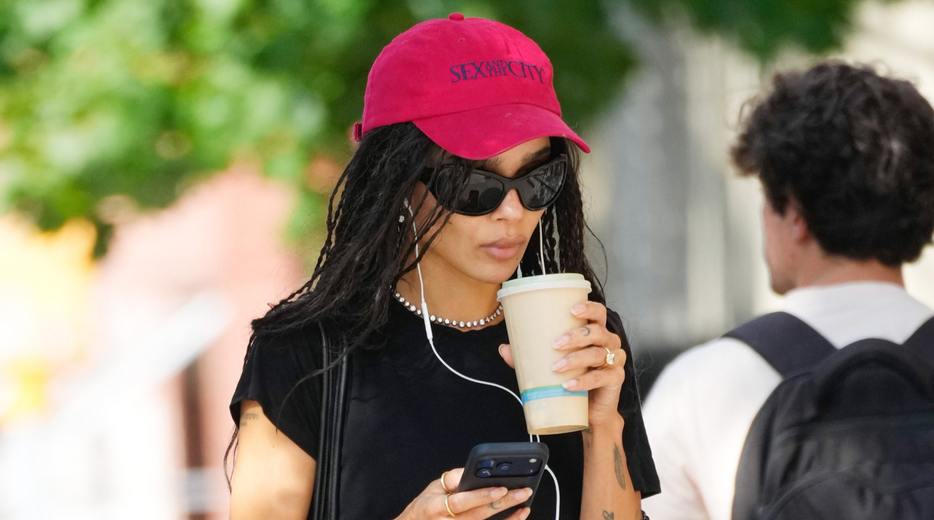 Zo&euml; Kravitz wears a red Sex and the City baseball cap, blue Adidas shorts, and rubber slides on August 28, 2026 in New York City