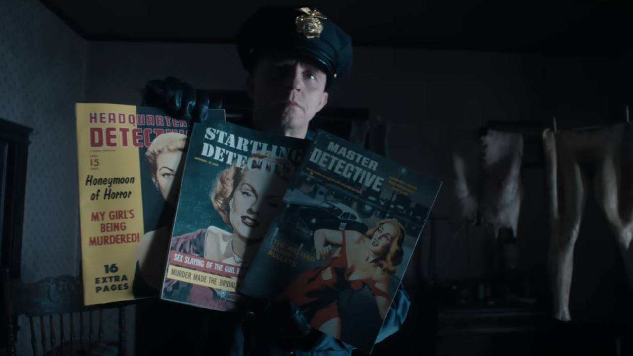 A cop holding up magazines in Monster: The Ed Gein Story