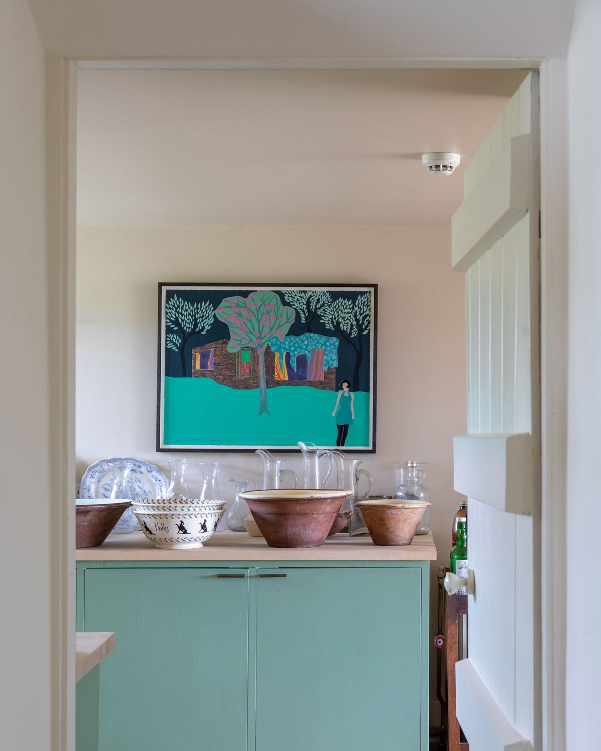 warm white kitchen painted in Farrow & Ball's Joa's White paint color in kitchen with blue cabinetry