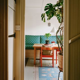 Check green banquette seating with wooden table