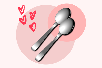 Two spoons on a pink background, illustrating what spooning is