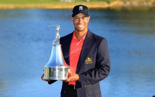 Tiger Woods holds the trophy after winning the 2012 Arnold Palmer Invitational