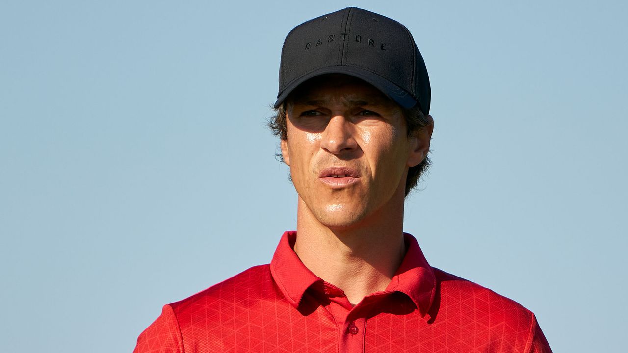 Thorbjorn Olesen headshot image wearing red shirt and black cap