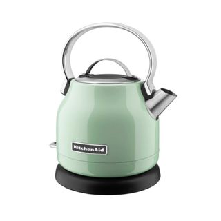 A pistachio green kettle with silver handle and spout, standing on a black base