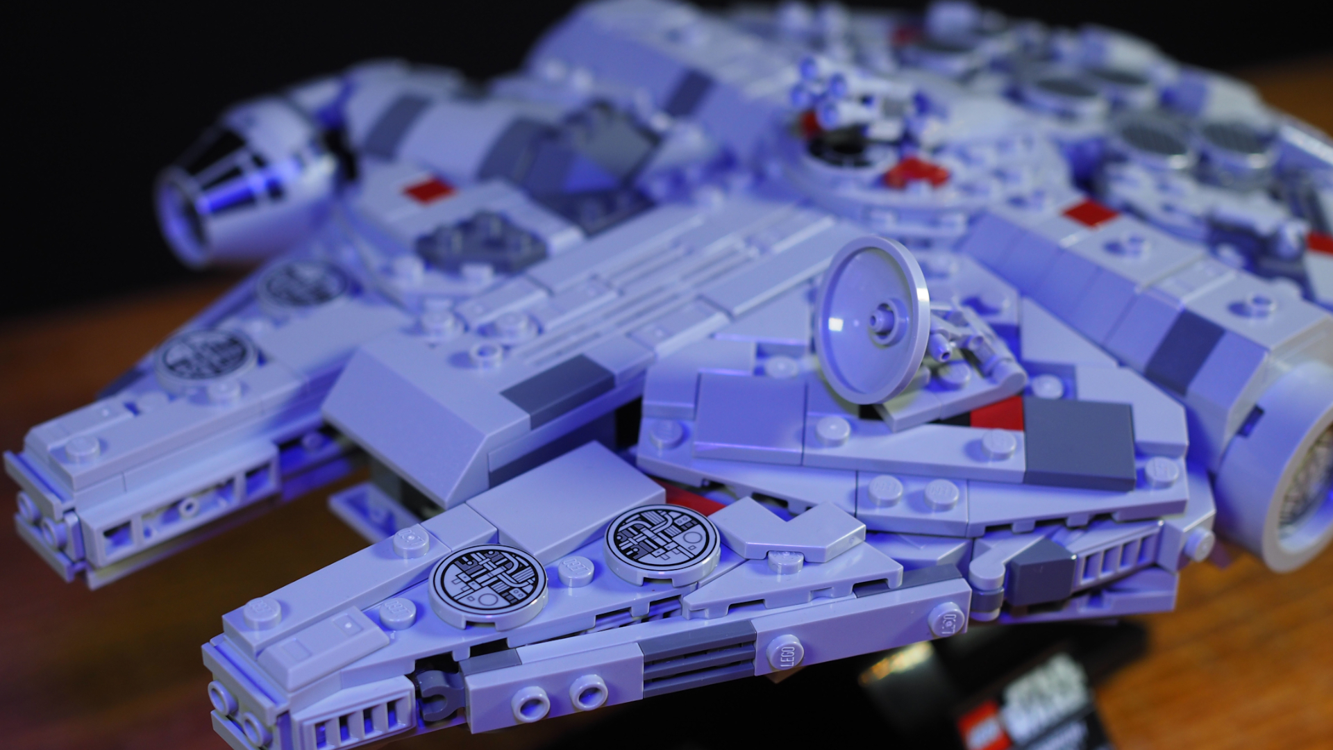 Lego Millennium Falcon set laid out on a wooden surface