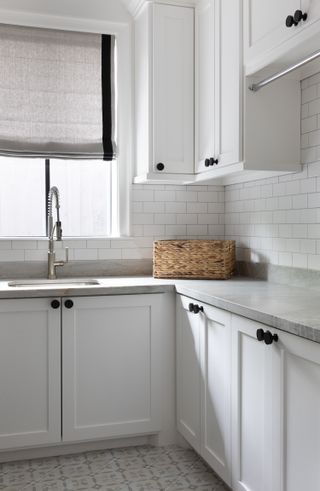 A small laundry room in white and gray