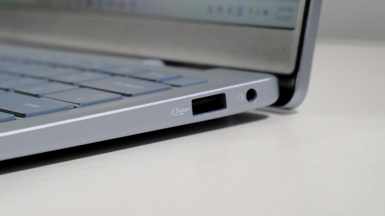Dell 14 Plus open on a white desk, highlighting the ports on the right.