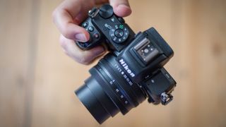 Nikon Z50 being held in one hand by our reviewer