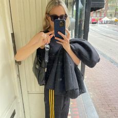 an influencer wears adidas track pants