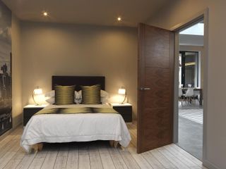 Bedroom with walnut door by JB Kinds