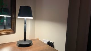 Philips Hue Go portable table lamp on a bedside table