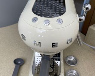 A close-up of Smeg coffee maker showing 3-button operation