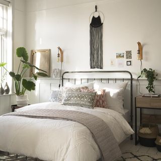 bedroom with cream wall and potted plant