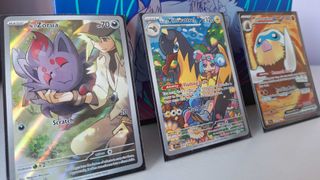 Three Pokemon Journey Together cards leaning against the Elite Trainer Box from the set