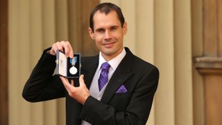 Thai Cave diver Chris Jewell poses with The Queen's Gallantry Medal which her received for his part in the Tham Luand Nag Non cave rescue
