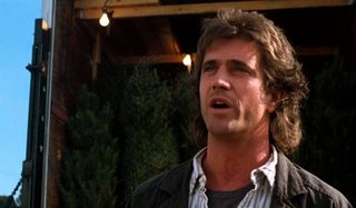 Lethal Weapon Mel Gibson talking in front of a truck of Christmas trees