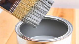 Paintbrush in paint tin