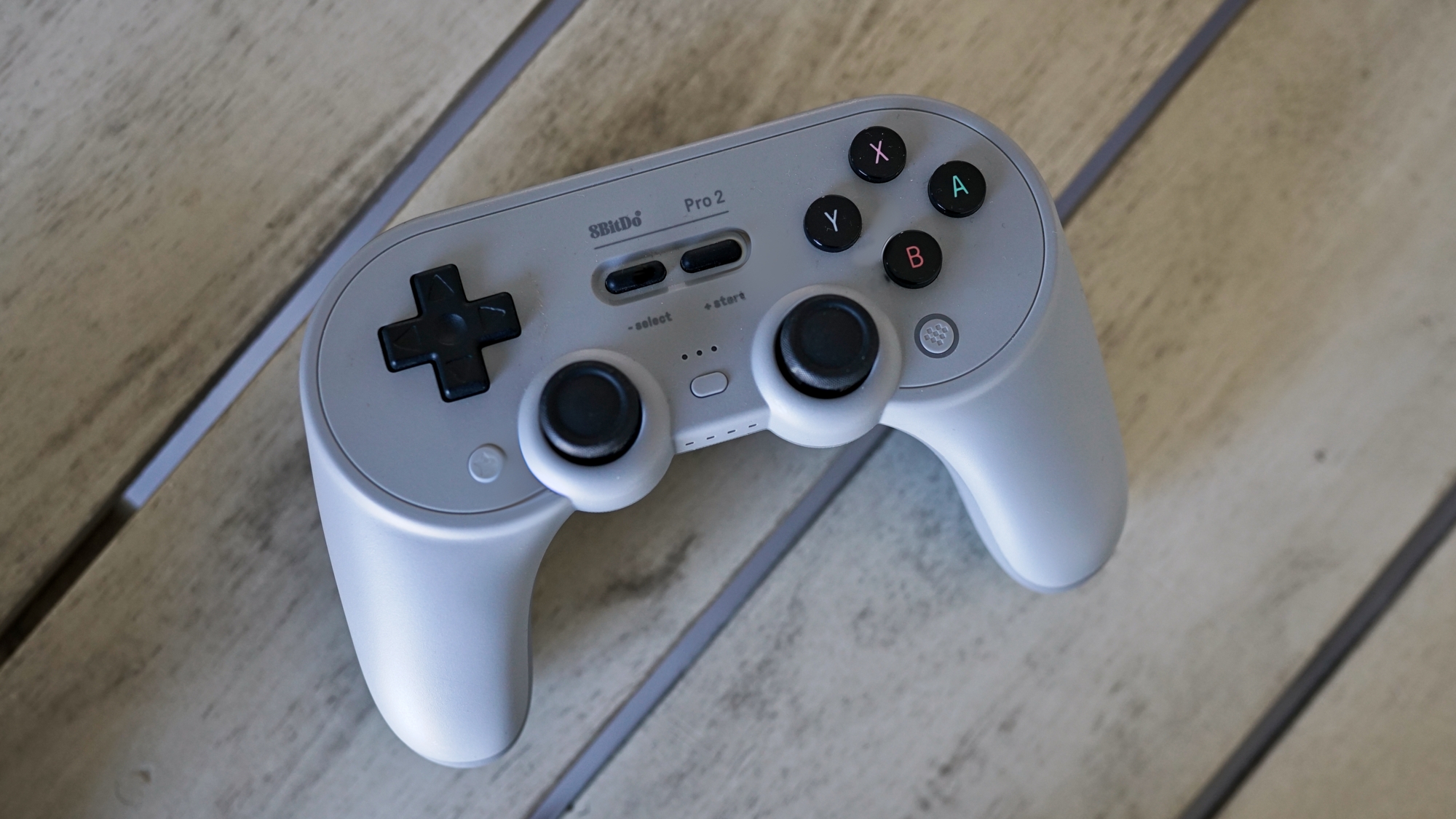 8BitDo Pro 2 controller sitting on a table.