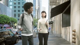 Man and woman walking on a city sidewalk