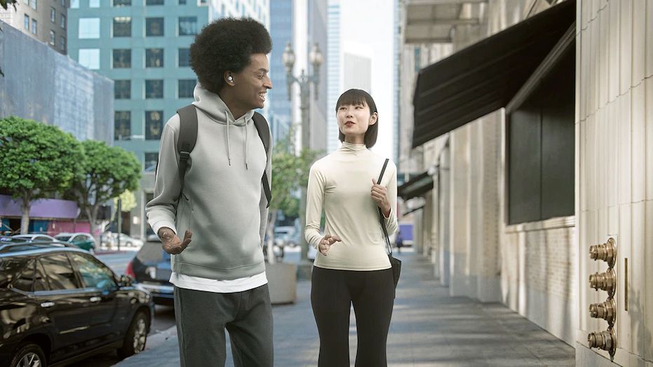 Man and woman walking on a city sidewalk