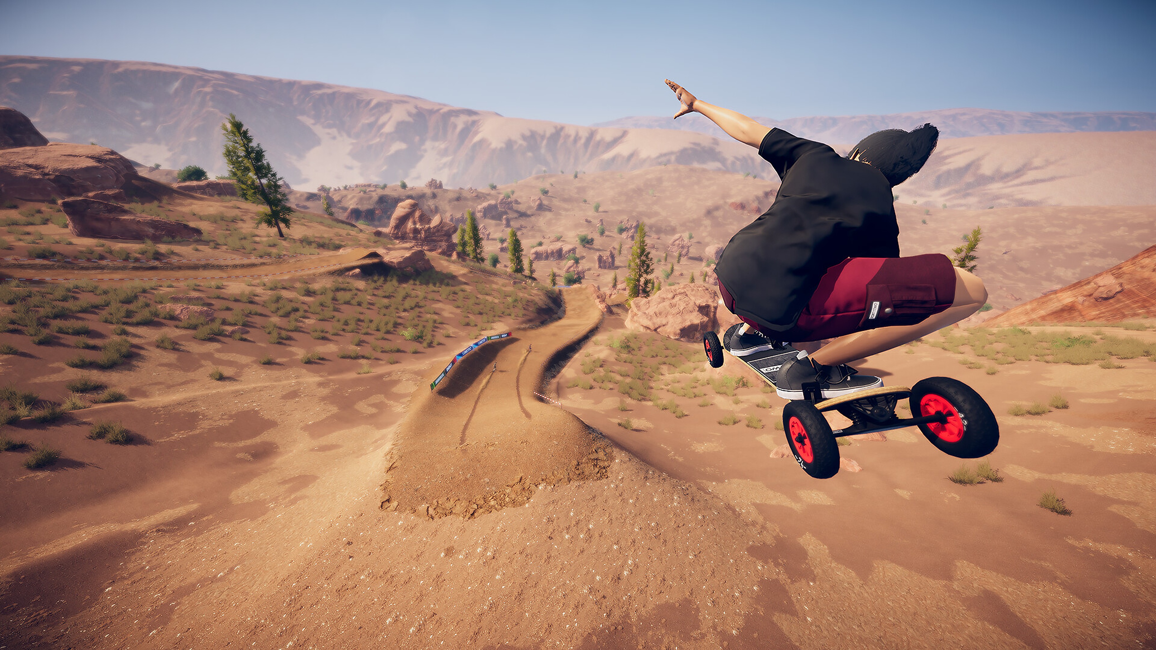 Promotional screenshot of a player racing through a desert in Descenders Next