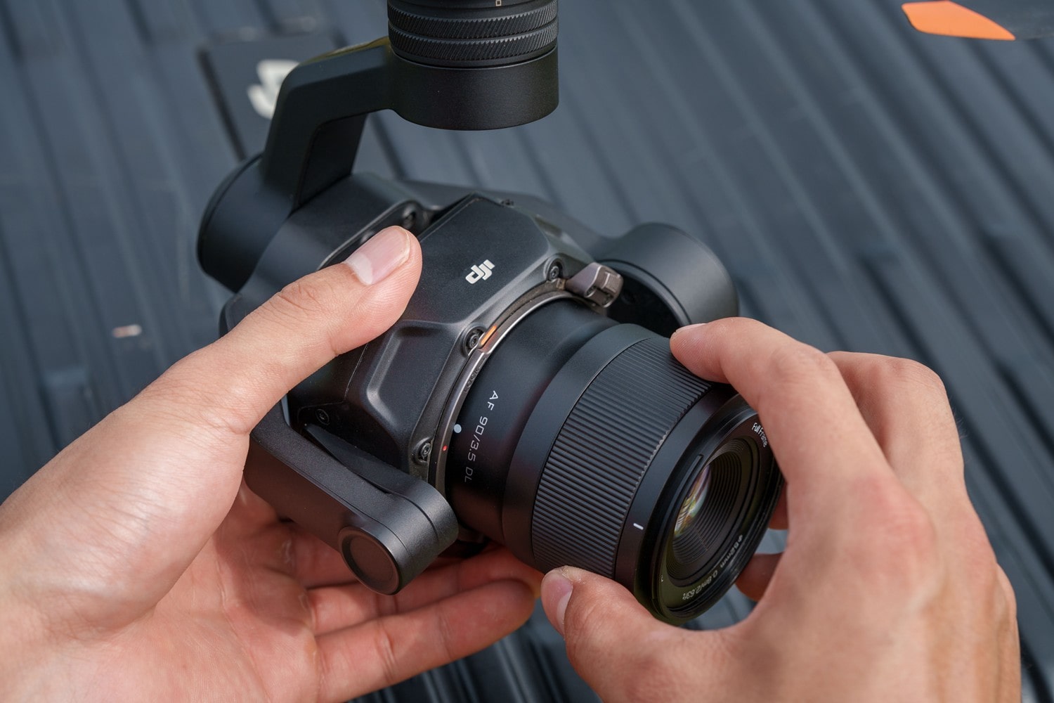 Viltrox AF 90mm F3.5 DL in hand on Inspire 3