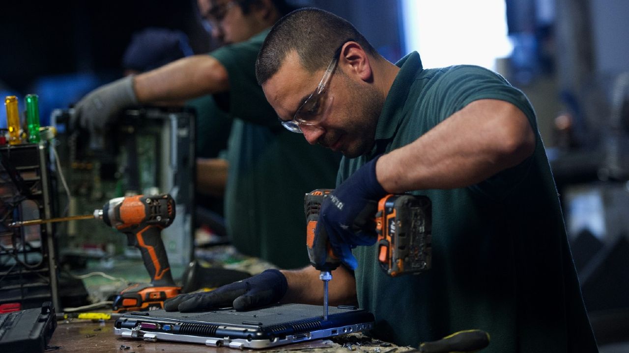 A man refurbishing a laptop