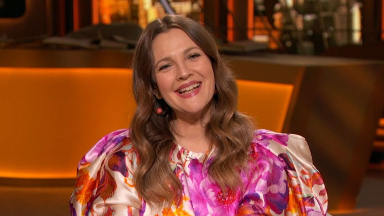 drew barrymore wearing pink on an orange background