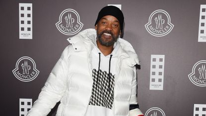Will Smith smiling in a big puffy jacket as he is photographed at an event