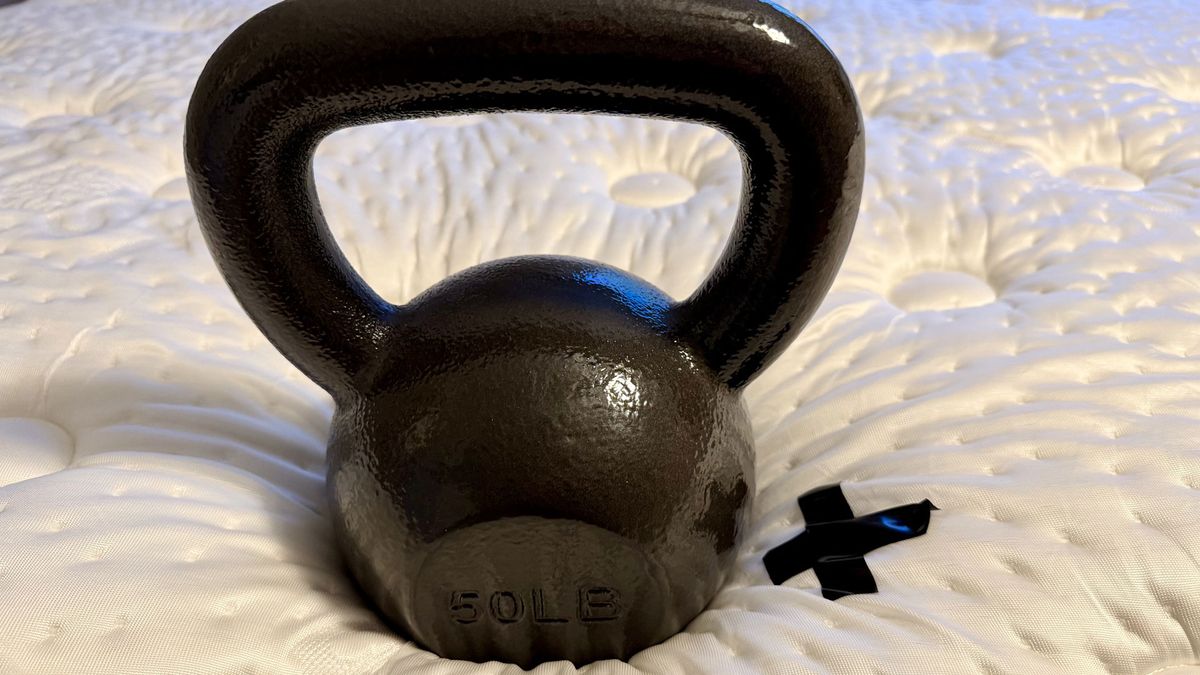Testing the Winkbed mattress's pressure relief with a kettlebell