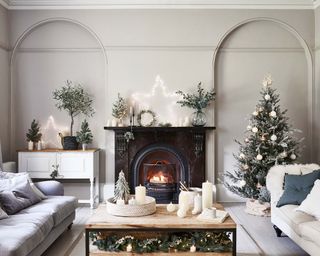 living room full of Christmas decorations, a christmas tree and cosy fireplace