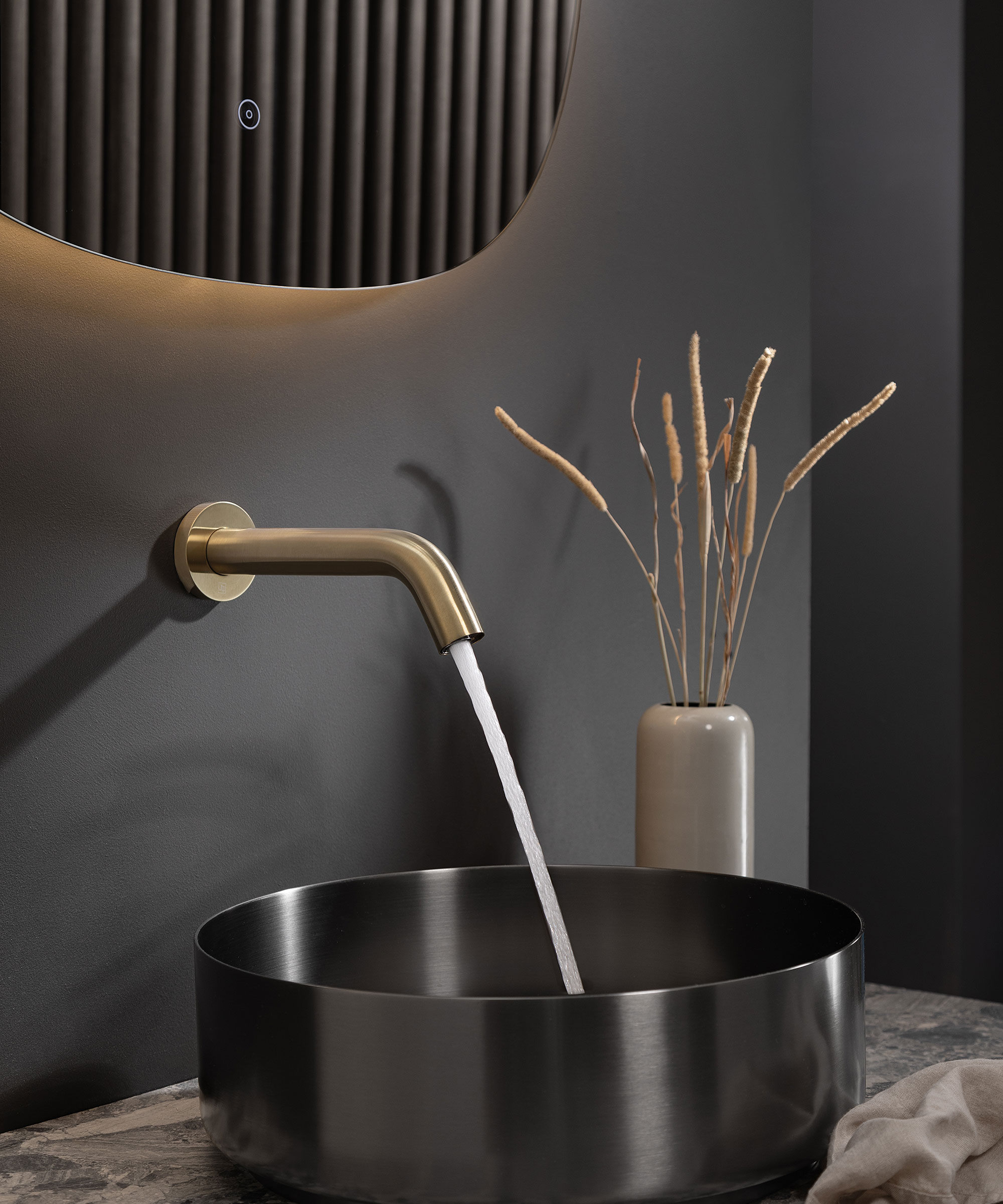 black countertop bathroom basin with modern brass bathroom tap