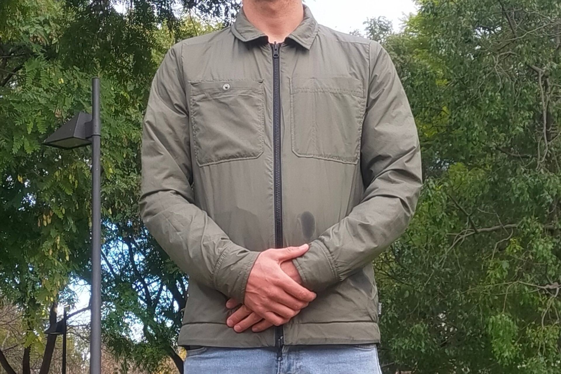 Image shows a rider wearing the Chrome Industries Two Way Insulated Shacket which is one of the best commuter cycling jackets