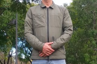 Male cyclist wearing the Chrome Industries Two Way Insulated Shacket which is one of the best commuter cycling jackets