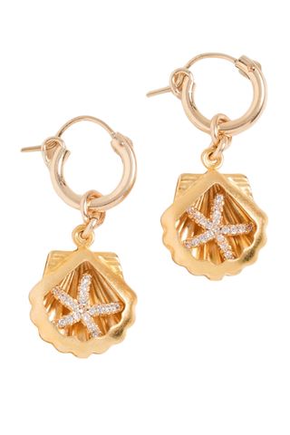 Brinker + Eliza gold shell Harbor Huggies earrings on white backgorund