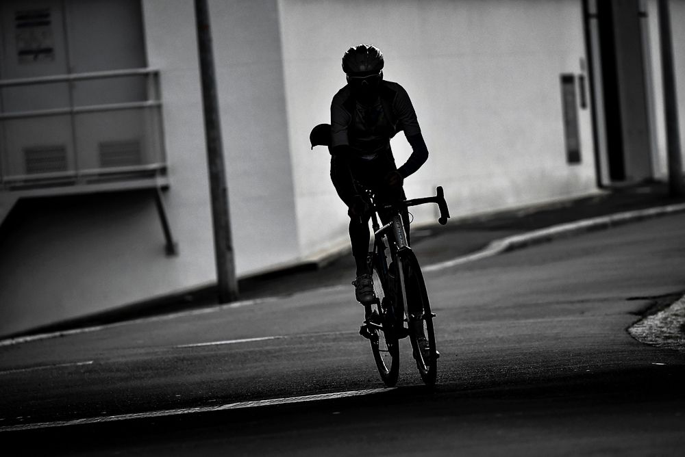 The silhouette of France's Romain Bardet of the AG2R La Mondiale cycling team is seen as he prepares to take part in a training session in Saint-Lo