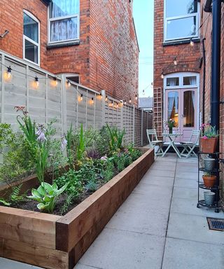 patio with raised planter filled with shrubs