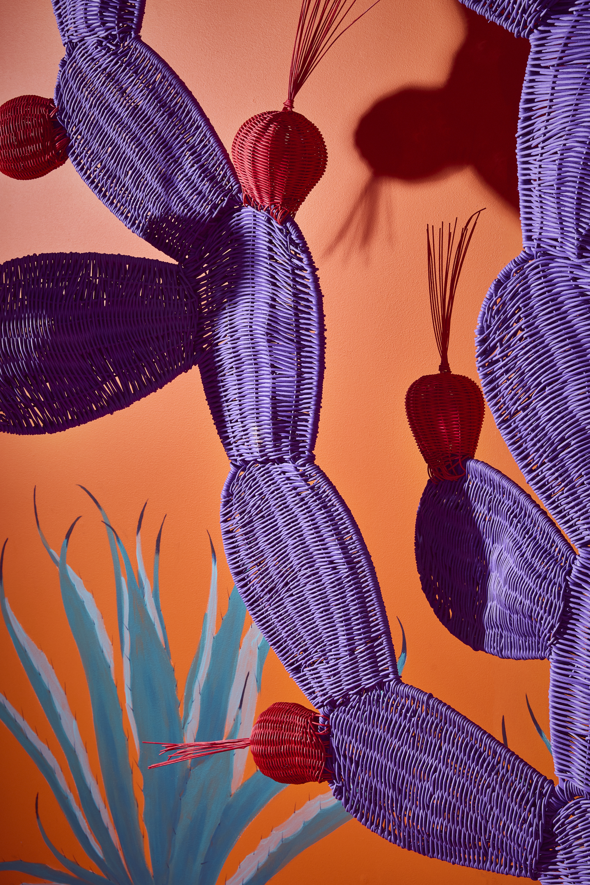 Installation view of ¡hola, London!, a whimsical art installation made of whicker-made furniture molded after dragons, cacti, and fantastical creatures, at sketch London.