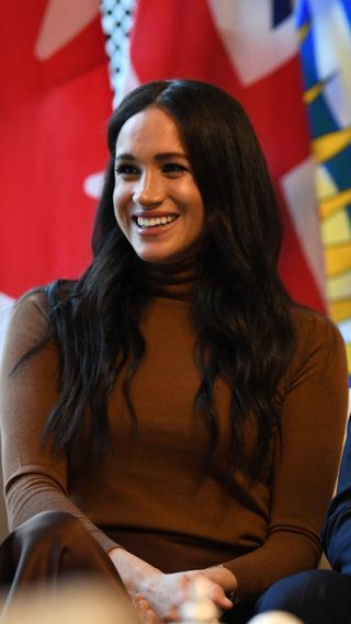 Meghan, Duchess of Sussex reacts during her visit to Canada House