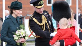 Catherine, Duchess of Cambridge and Prince William, Duke of Cambridge speaks to an young guest as they attend the 1st Battalion Irish Guards' St. Patrick's Day Parade at Mons Barracks on March 17, 2022 in Aldershot, England.